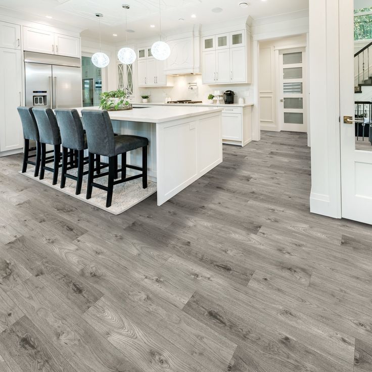 A kitchen with hardwood floors and a large island.
