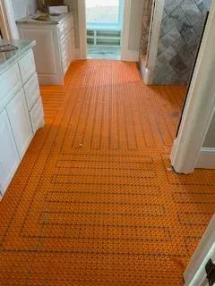 A bathroom with a tiled floor and a heating system.