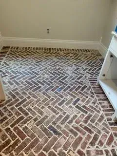 A brick floor with a herringbone pattern in a kitchen.