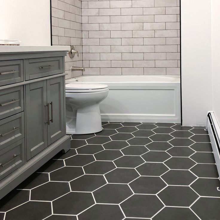 A bathroom with a toilet a sink and a bathtub