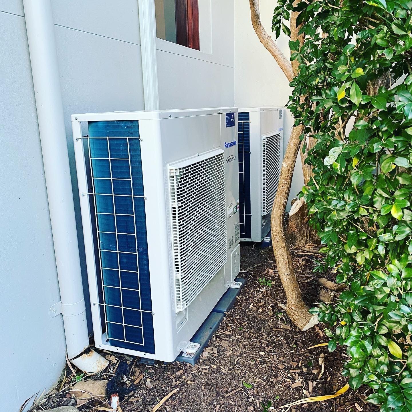 Blue Bedroom With White Trim, a Mini-split Ac Unit, and a Hanging Light Fixture — Airset Air Conditioning in Bellingen, NSW