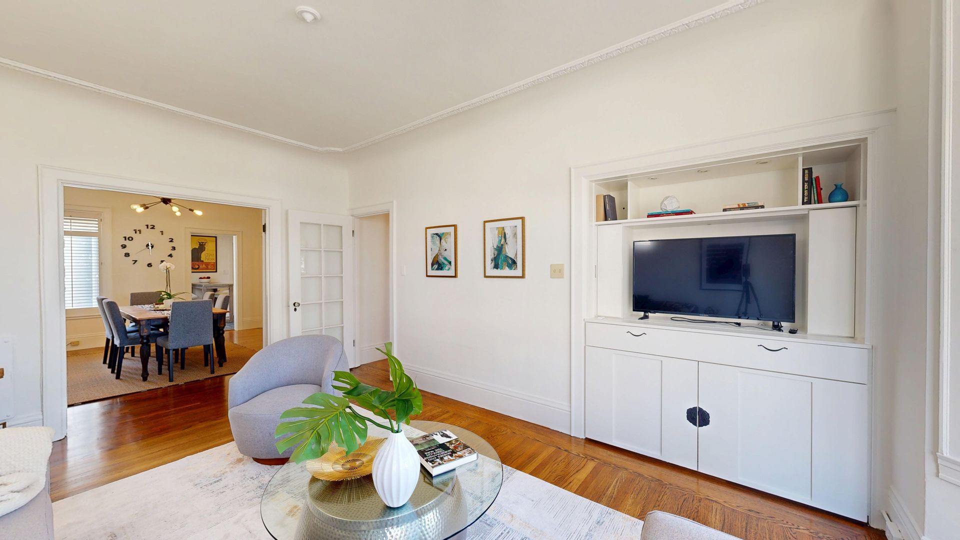living room tv coffee table chair peek at dining room