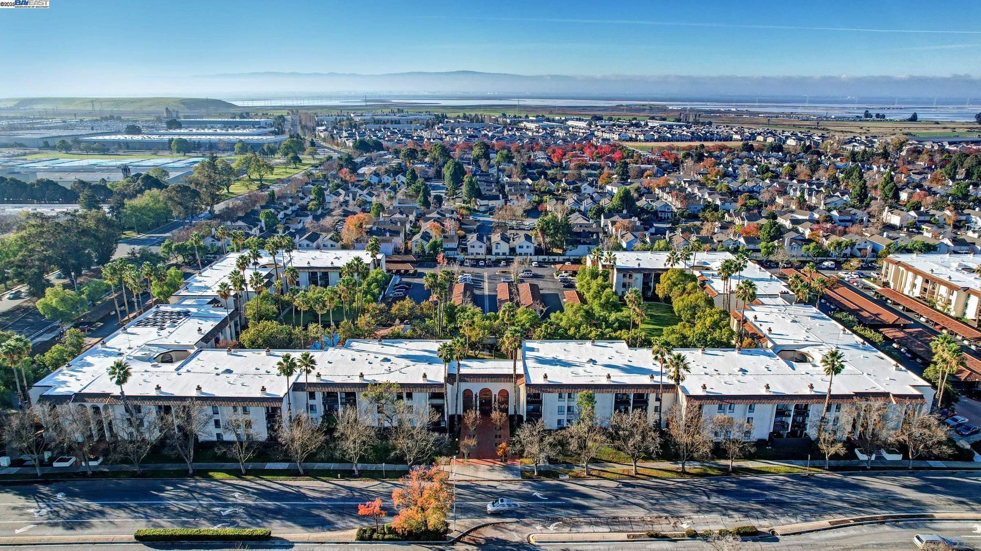 An aerial view of a residential area with lots of buildings and trees.