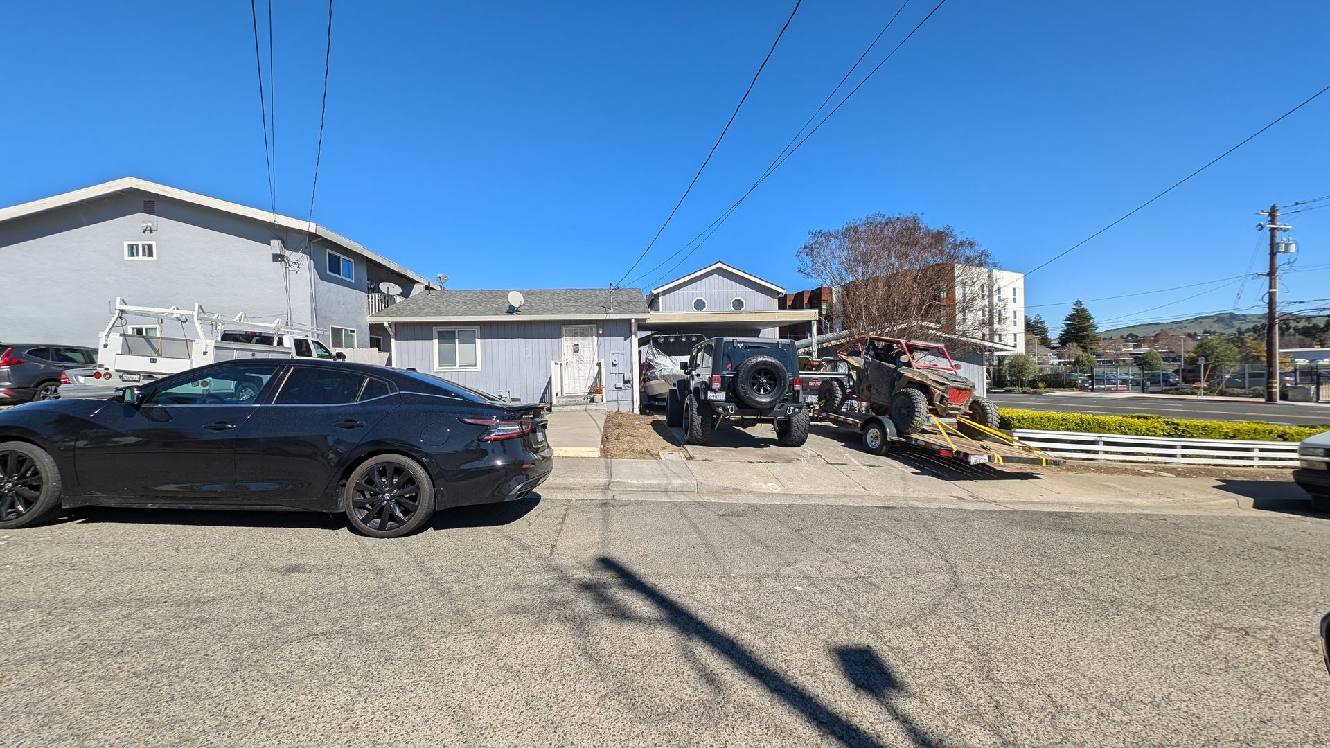 across the street view of frisbee with car in carport