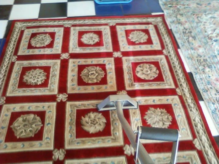 Cleatterned rugs, various sizes, folded and layered.