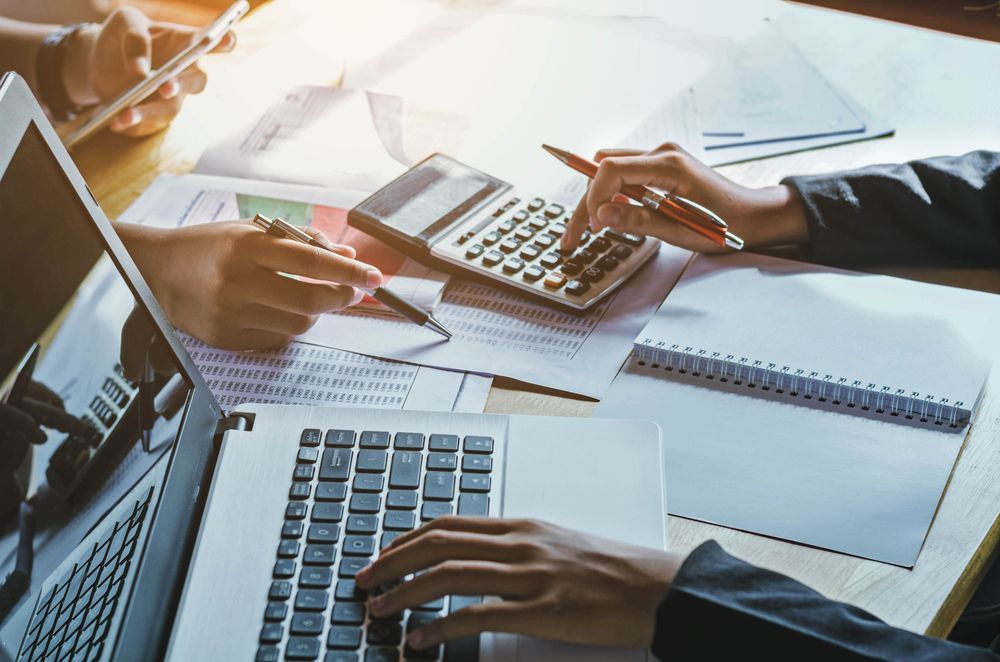 A Group of People Are Using Laptops and Calculators — Townsville Accounting In Hyde Park, QLD