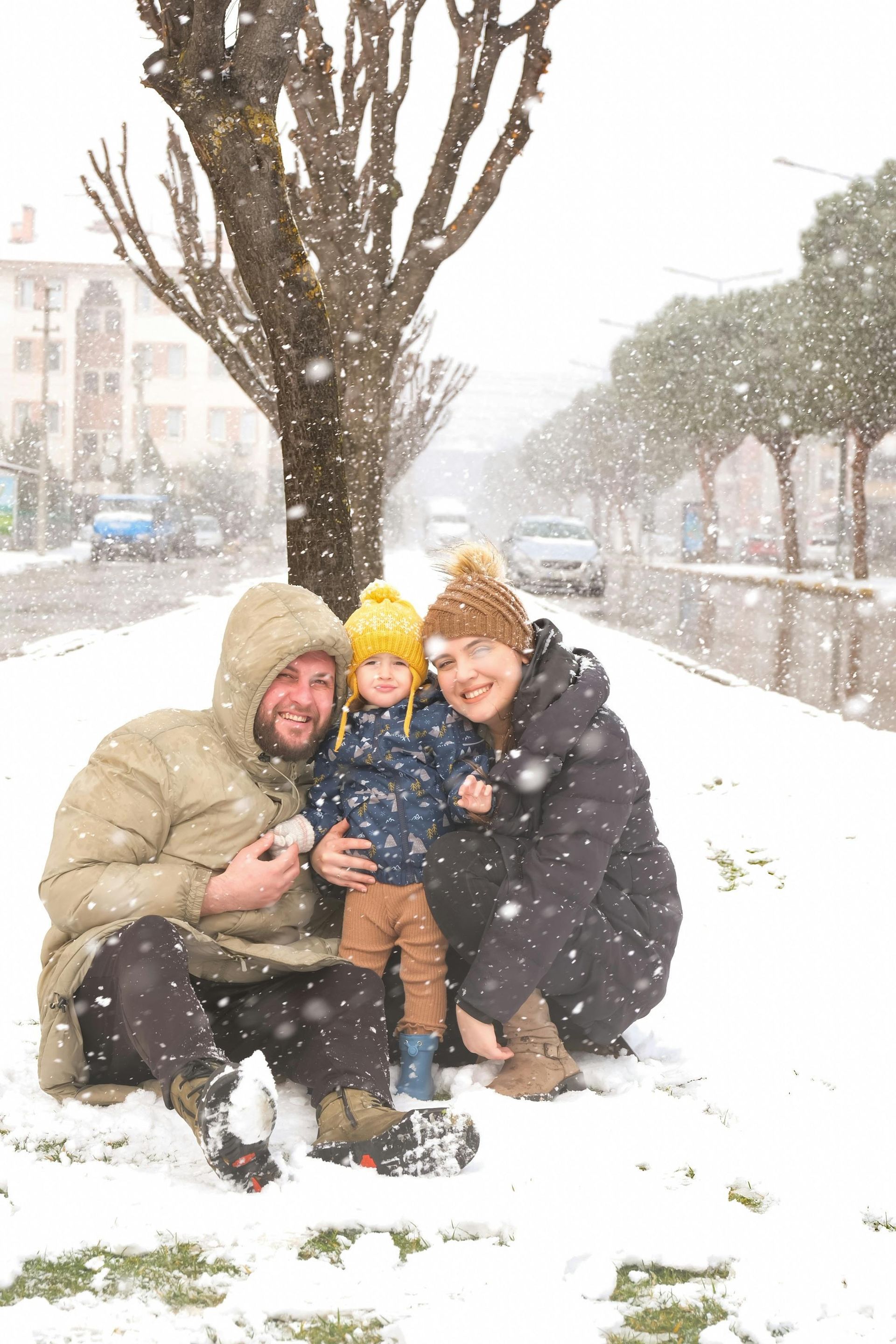 A family is posing for a picture in the snow.