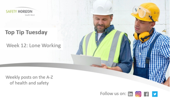 Two construction workers are looking at a piece of paper.