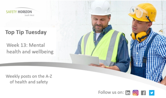 Two construction workers are looking at a piece of paper