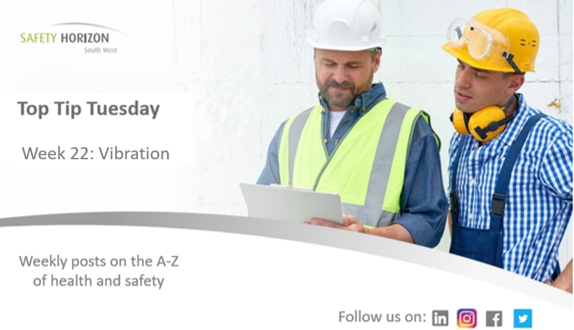 Two construction workers are looking at a piece of paper.