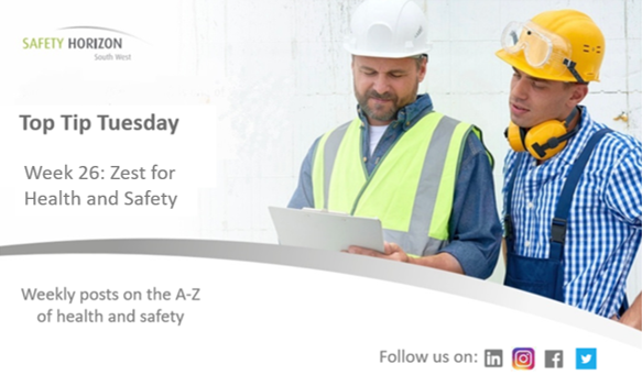 Two construction workers are looking at a piece of paper.