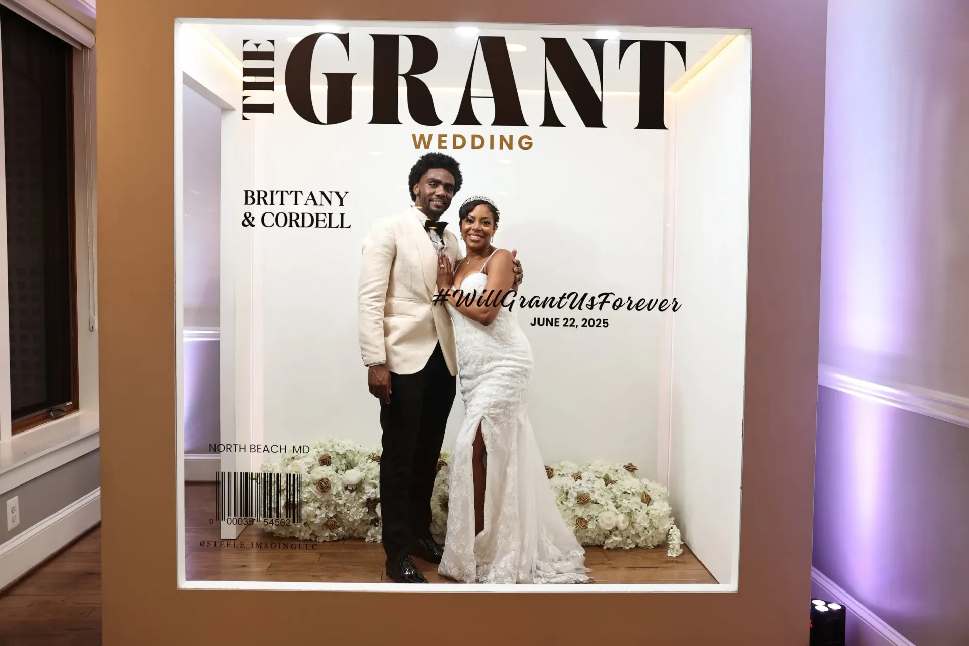Wedding poster with a couple posing in white and black formalwear in front of a large “GRANT” sign