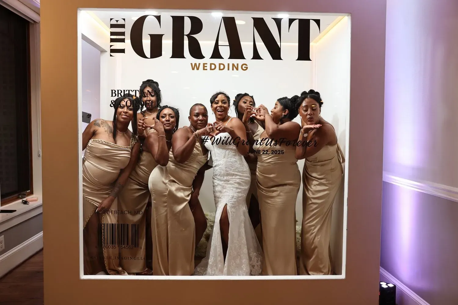 Wedding photo display with six women in gold and white dresses posing under “GRANT WEDDING” sign