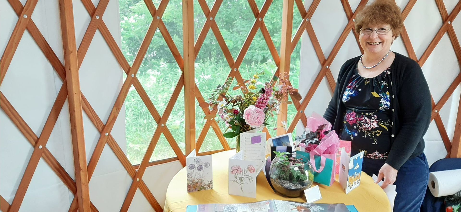 Community Restorative Justice Center: a lady standing beside a table with cards and flowers on it