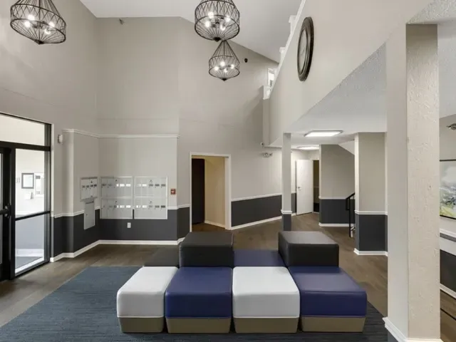 Lobby area with mailboxes and modern seating