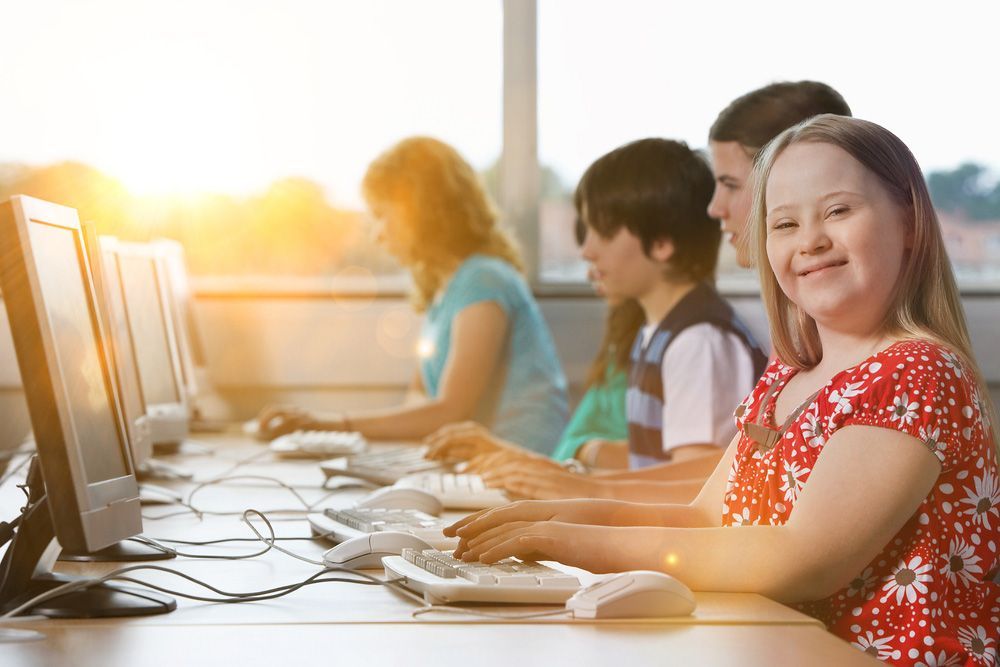 Girl with Down Syndrome Using Computer at School — Adaptive Care Pty Ltd In Tarneit, VIC