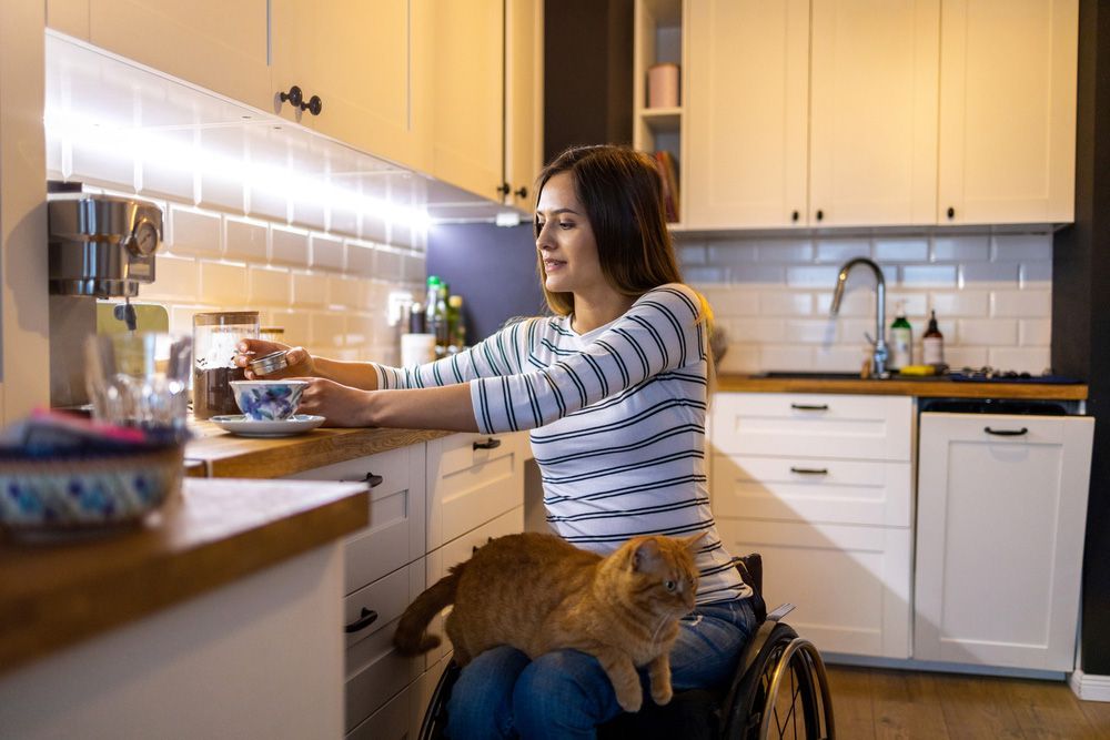 Woman in Wheelchair in Kitchen at Home — Adaptive Care Pty Ltd In Tarneit, VIC