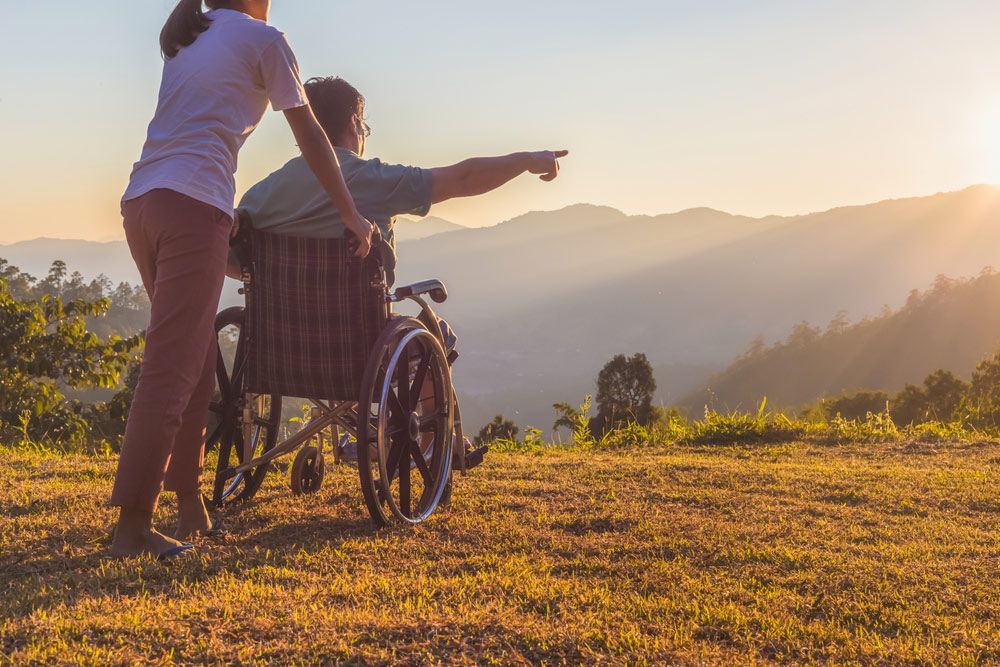 Person on a Wheelchair Pointing at the Beautiful View — Adaptive Care Pty Ltd In Tarneit, VIC