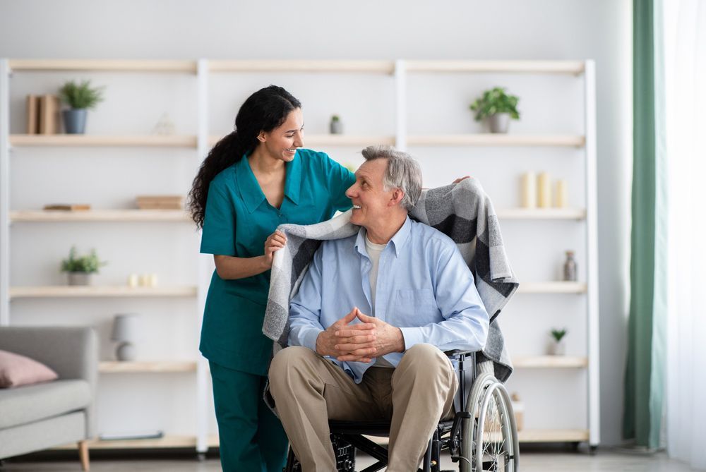 A Person Holding a Blanket Over a Person in a Wheelchair — Adaptive Care Pty Ltd In Tarneit, VIC