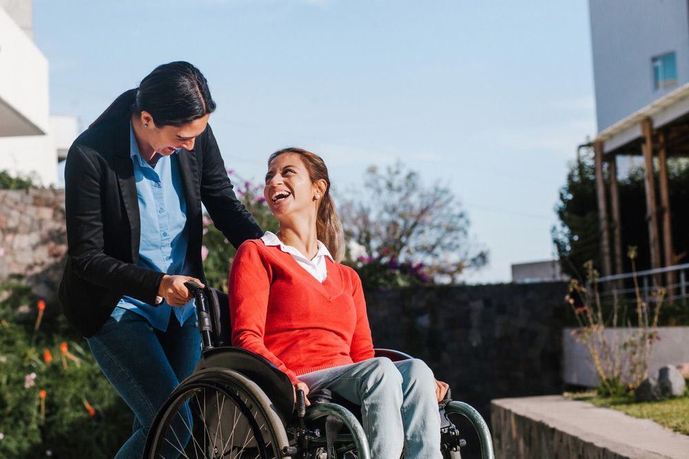 A Person Pushing a Person in a Wheelchair — Adaptive Care Pty Ltd In Tarneit, VIC