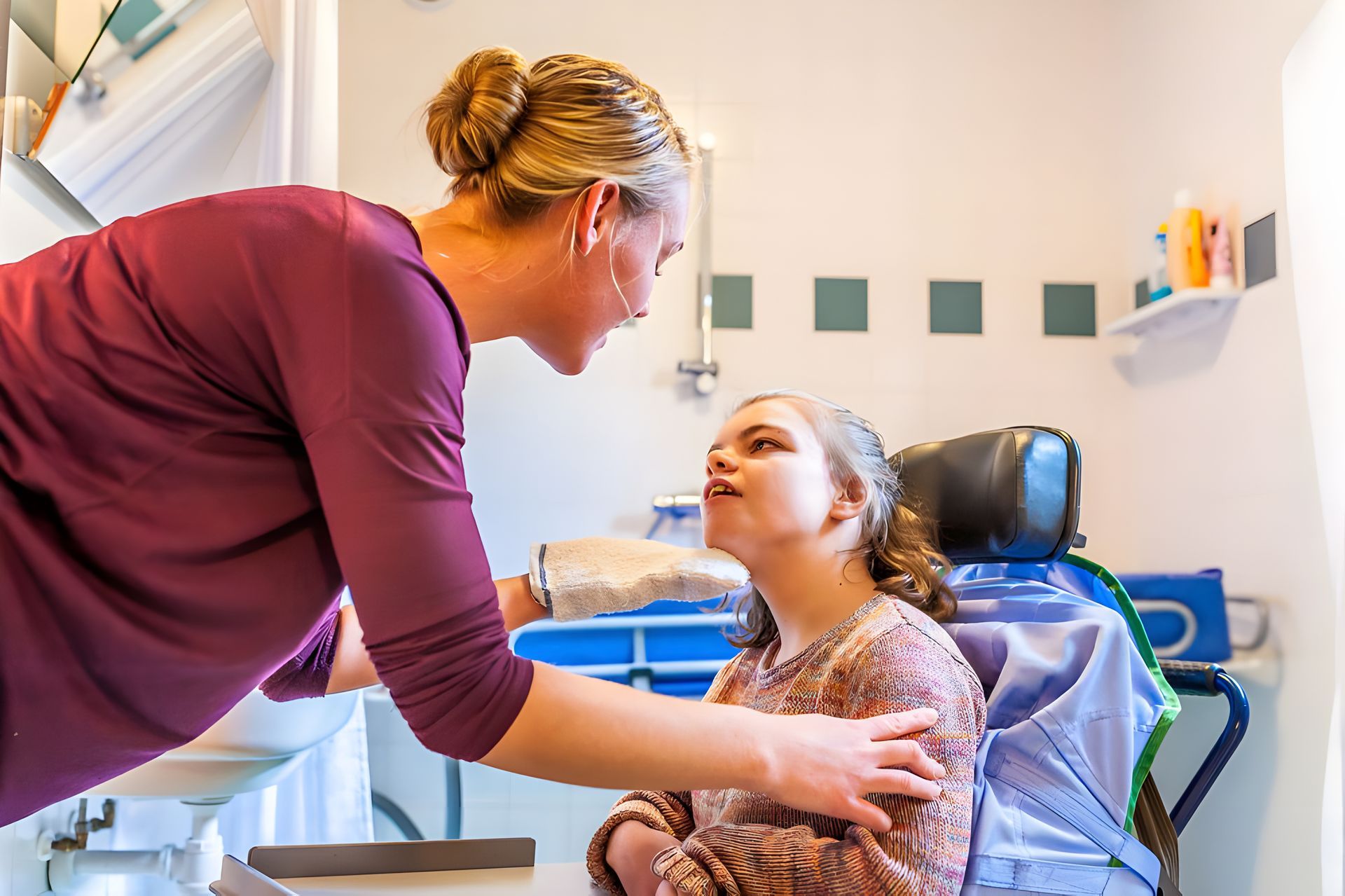 A Woman Is Standing Next To A Girl In A Wheelchair In A Bathroom — Adaptive Care Pty Ltd In Tarneit, VIC