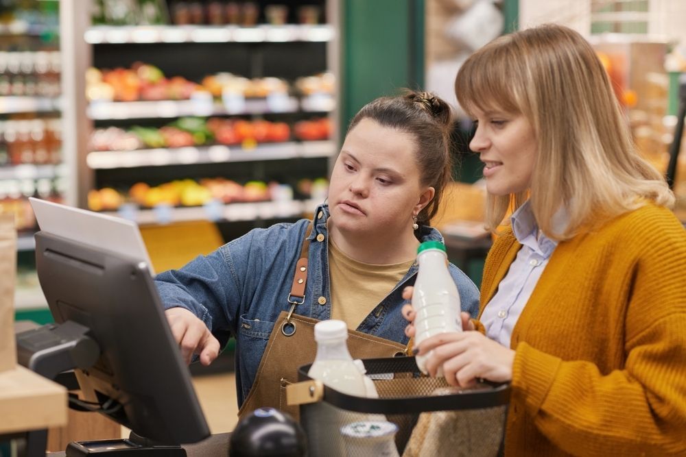A Cashier Assists a Customer at a Grocery Store — Adaptive Care Pty Ltd In Geelong, VIC
