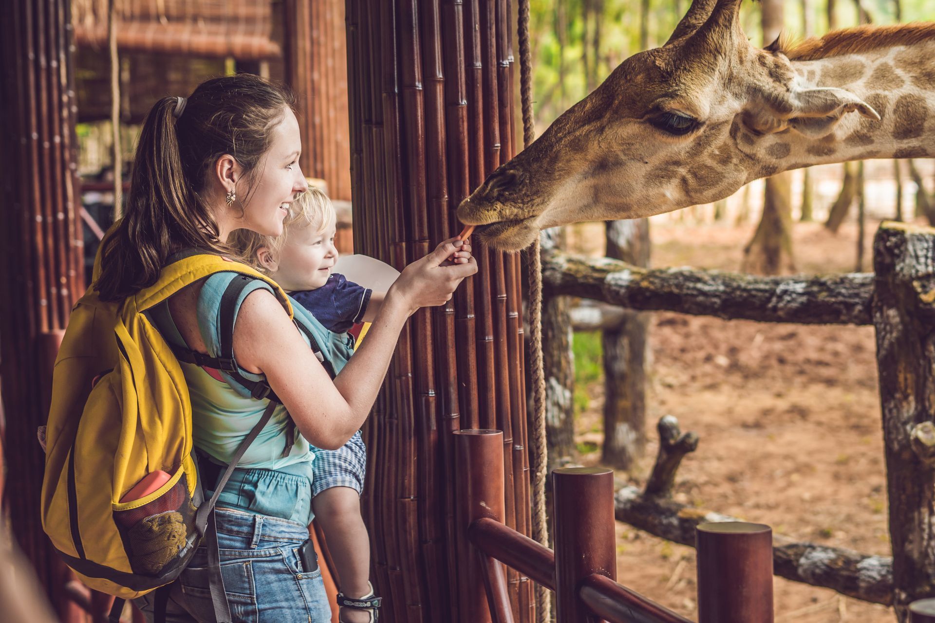 Woman and her baby with a giraffe