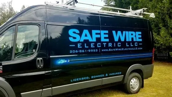 Blue Safe Wire Electric LLC van parked on grass with company logo on the side