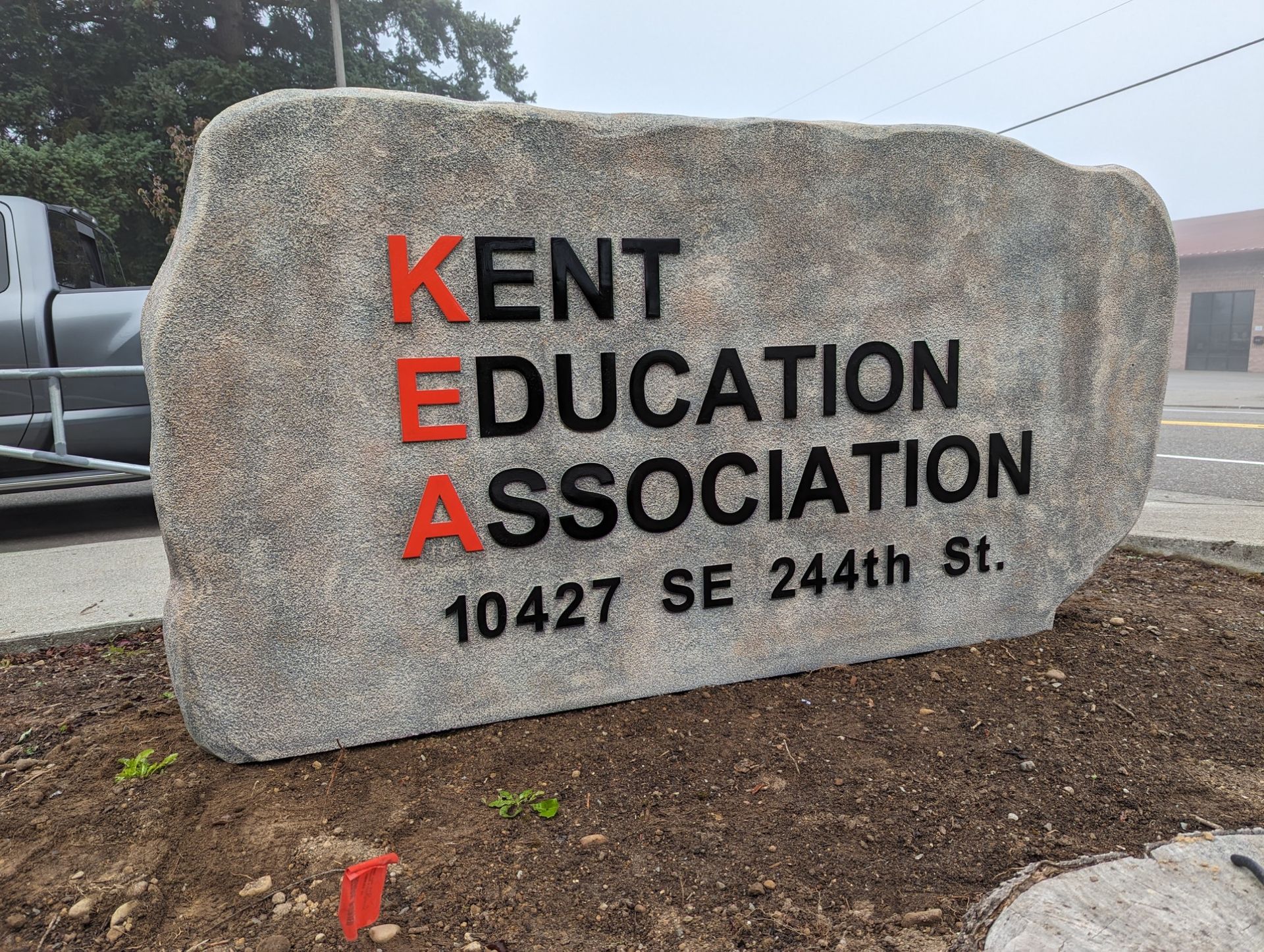 Kent Education Association sign with red and black lettering on a stone monument