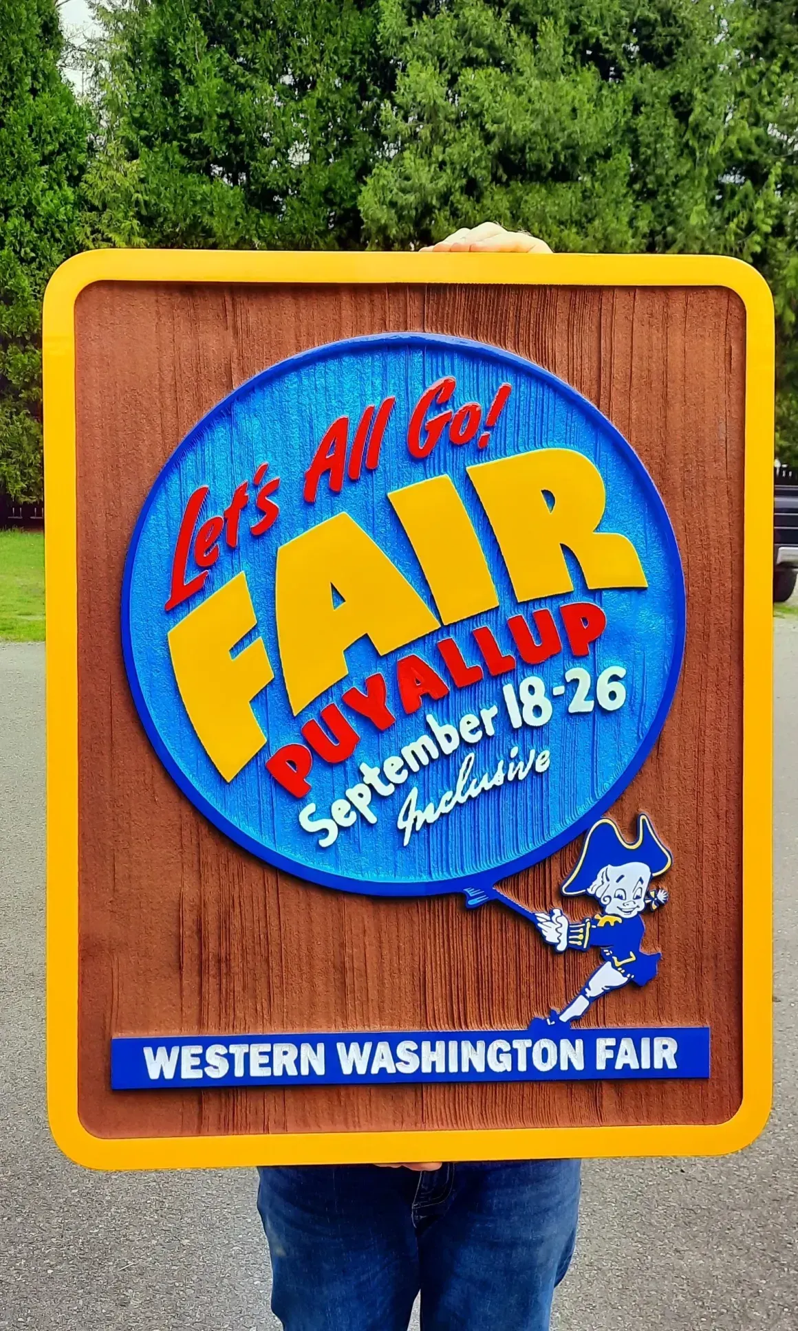 Western Washington Fair sign with blue and yellow logo and white text on a wood background created by Valley Sign