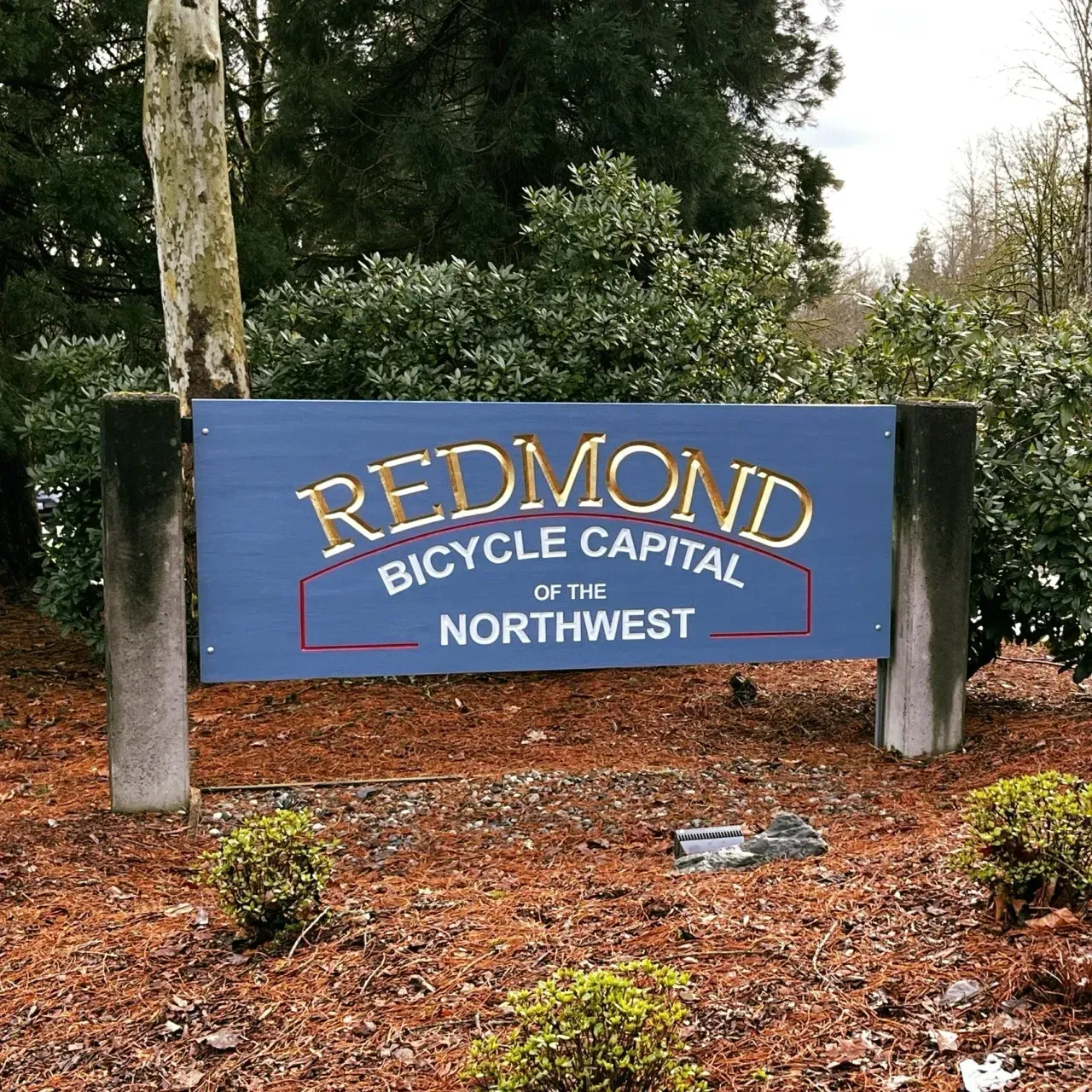 Redmond sign reading “Bicycle Capital of the Northwest” in a wooded landscaped area created by Valley Sign