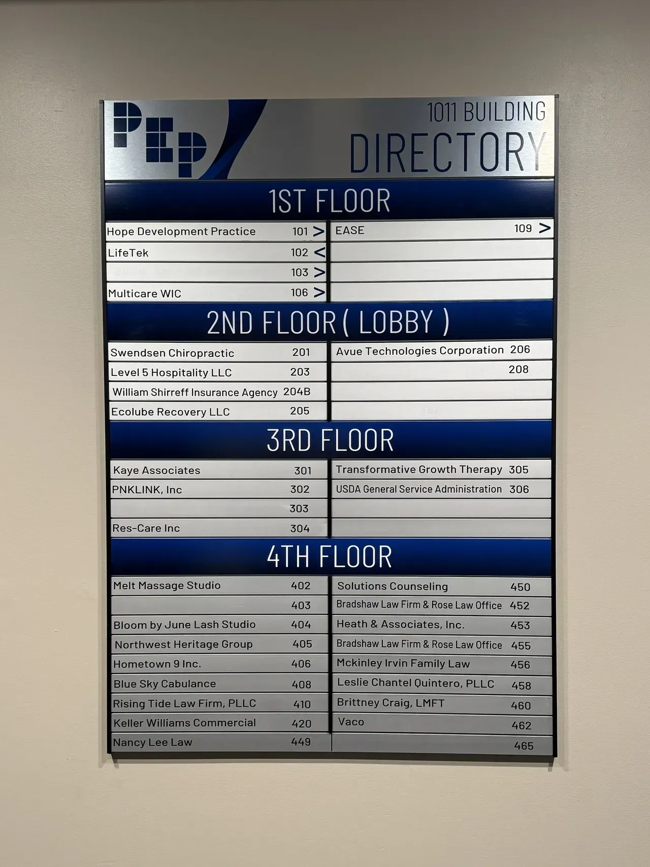 Building directory sign listing floors and offices in a lobby