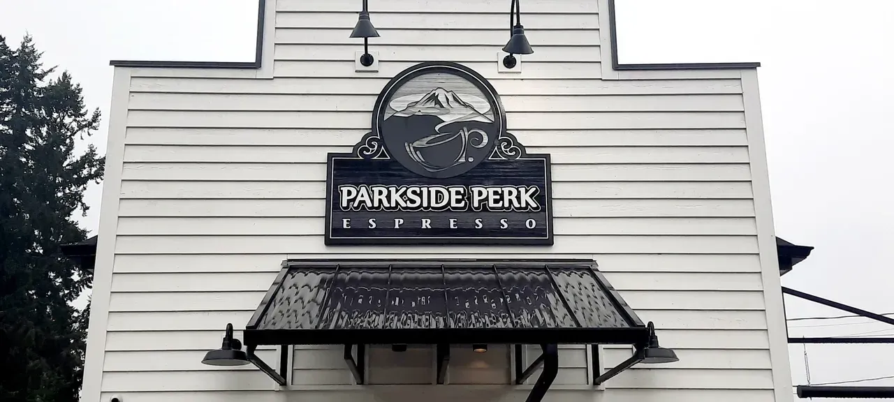 Parkside Perk storefront sign on a white building with a small awning