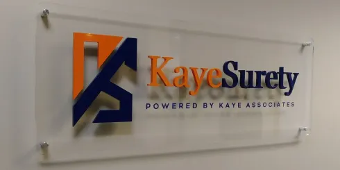 KayeSurety logo on a wall sign with orange and blue lettering and a blue-orange emblem created by Valley Sign