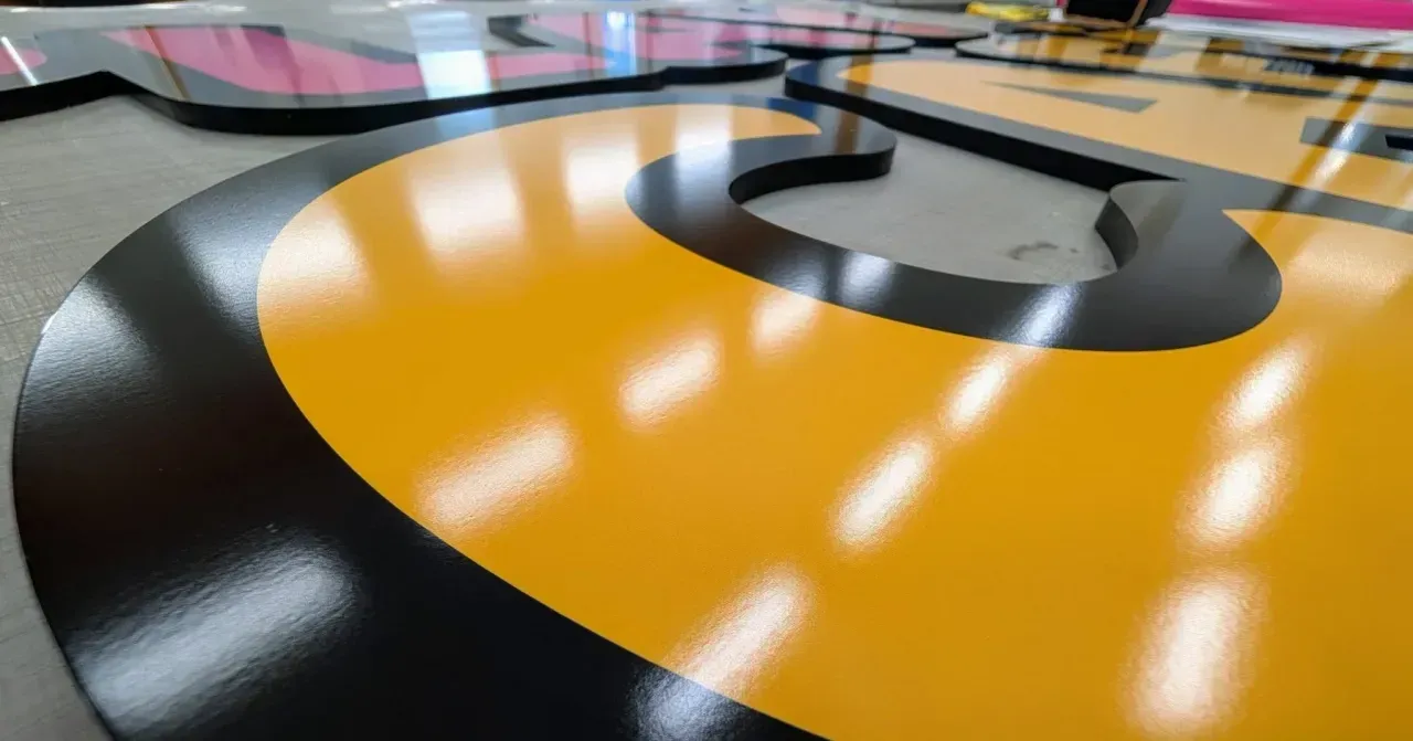 Abstract orange, black, and gray floor design with glossy reflections in an indoor space