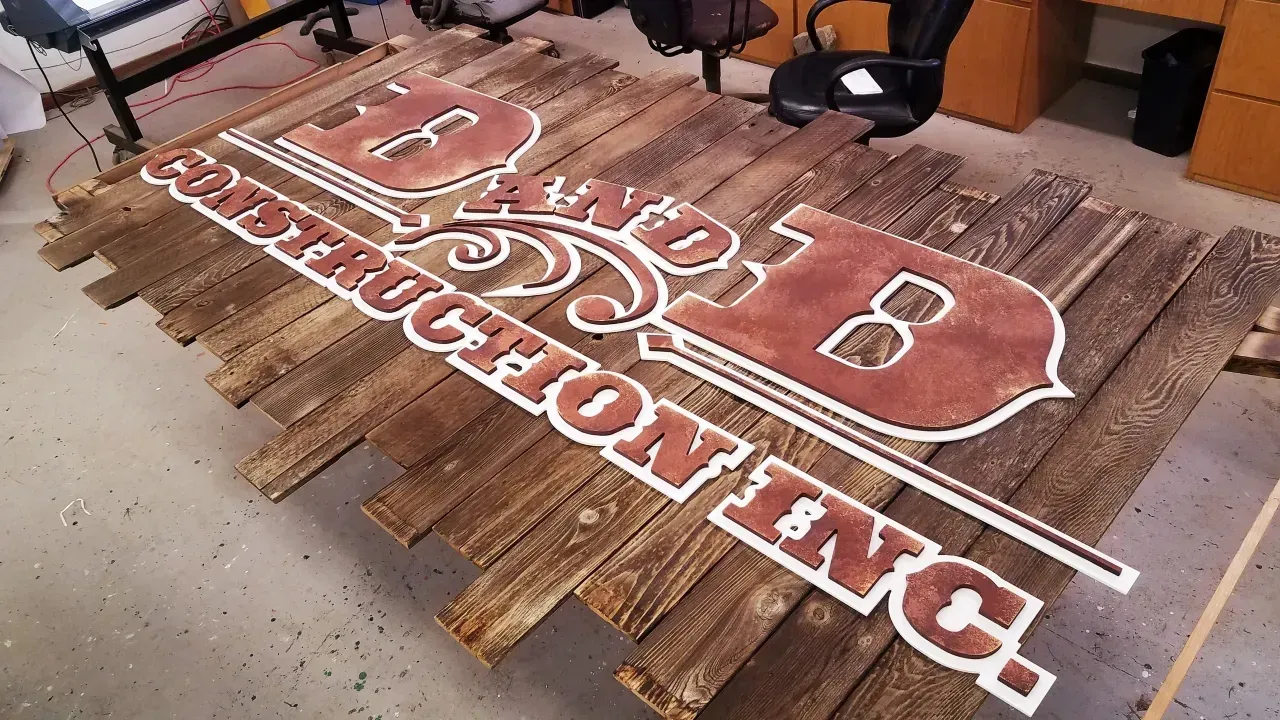 Wooden pallet sign with red-and-white lettering for “Midwestern,” in a workshop or garage setting