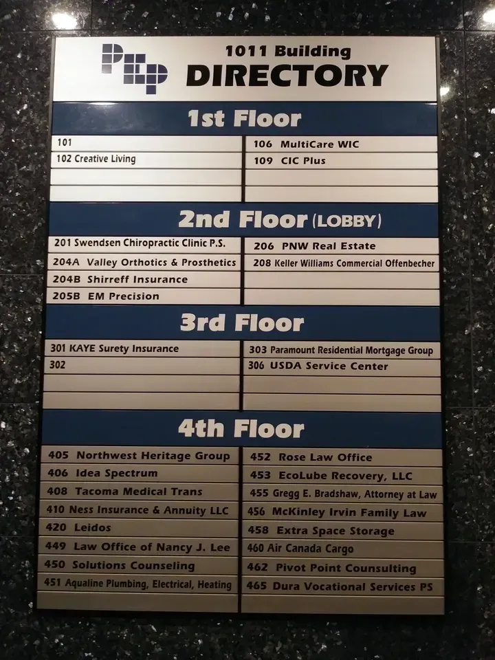 Building directory sign for 1011 Building with floor listings on a black-and-white board.