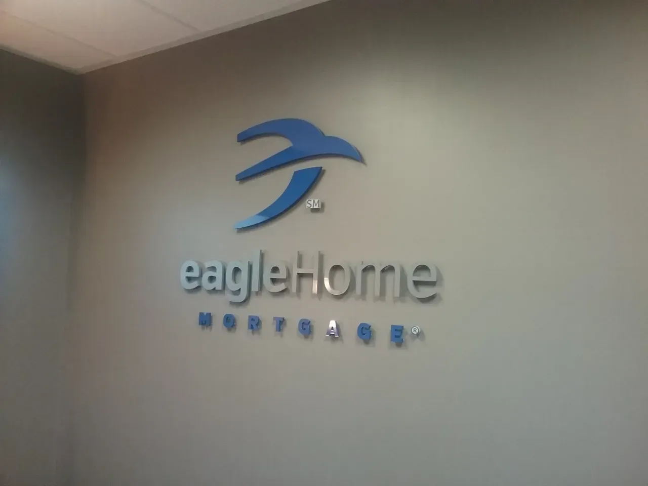 EagleHome Mortgage logo on a wall in blue lettering and icon