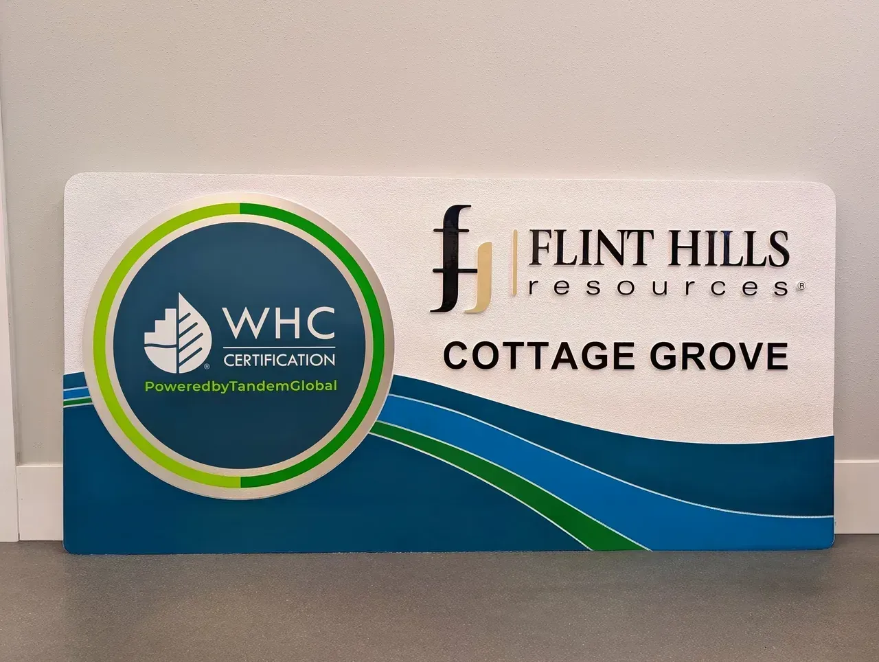 WHC and Flint Hills Resources Cottage Grove logos on a white and blue sign