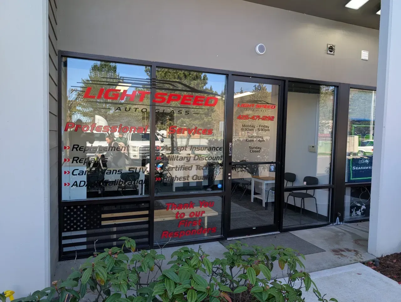 Storefront with large glass windows and red lettering for LightSpeed, seen from outside.