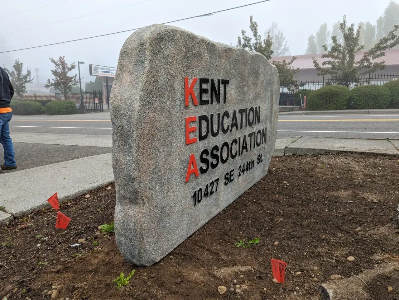 Kent Education Association sign on stone marker in a landscaped roadside area created by Valley Sign
