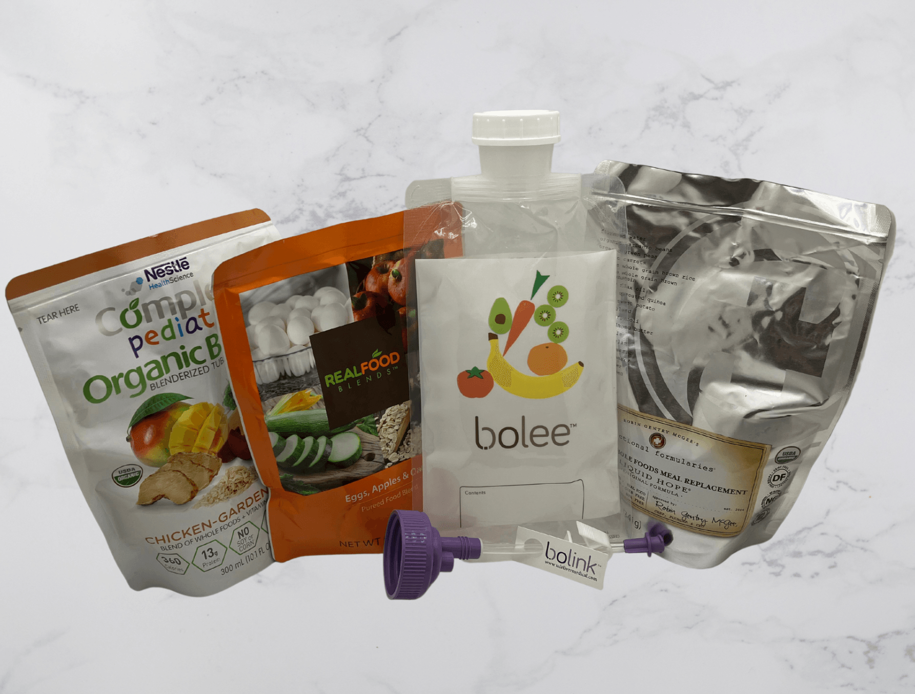 Bolee Bag and Bolink Large Cap in front of Compleat, Real Food Blends and Nourish pouches