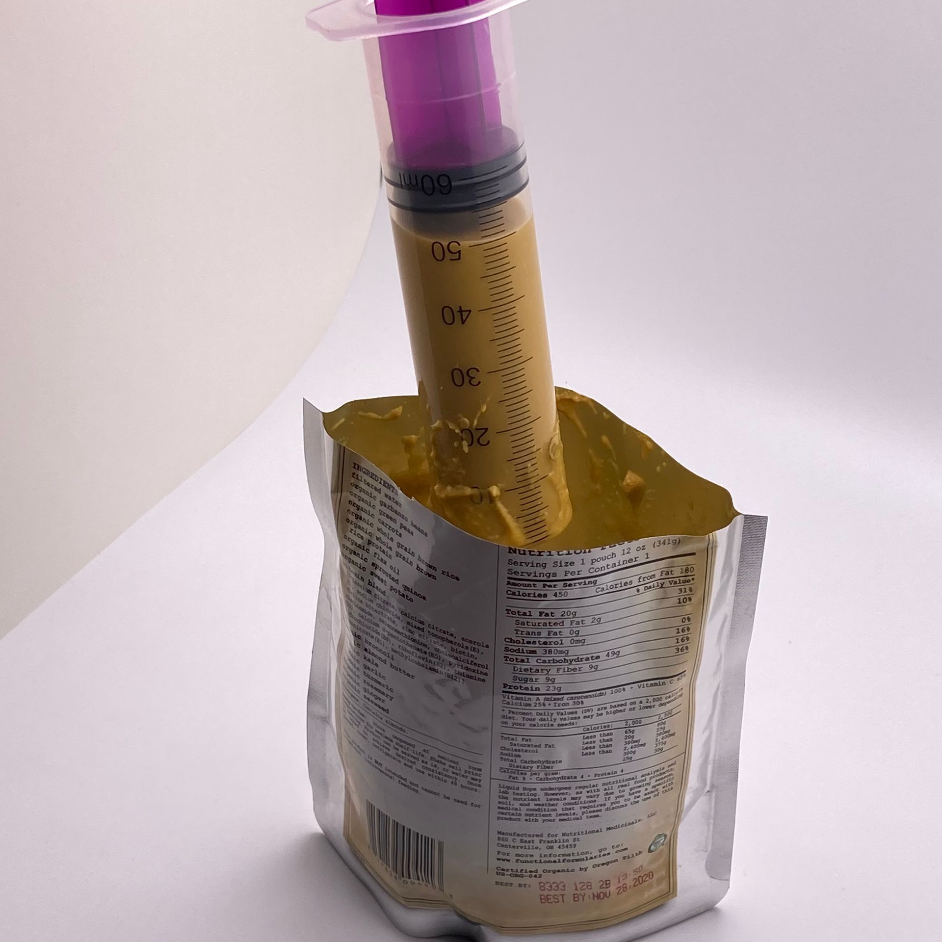 ENFit syringe attached to a Bolee bag using an Enfit transfer lid