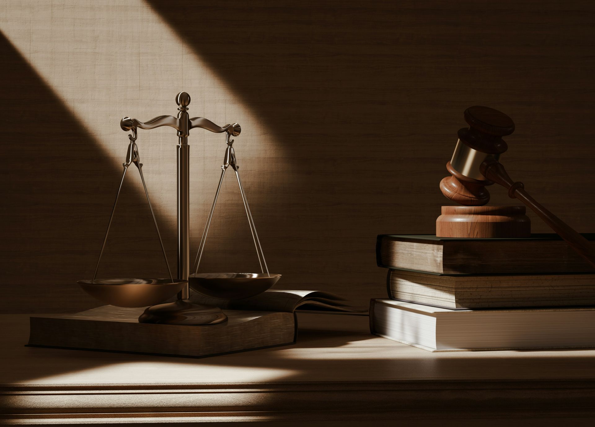 Scales of justice and gavel on stacked law books in warm light