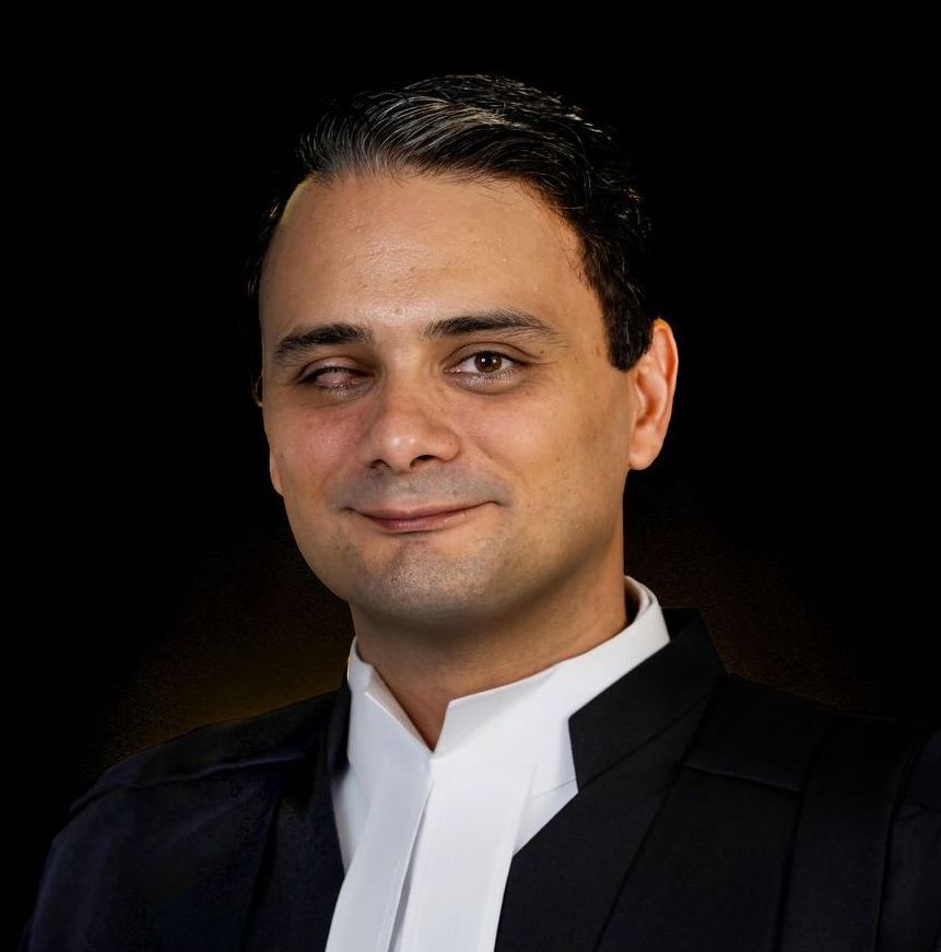 A man in a suit and tie is smiling for the camera.