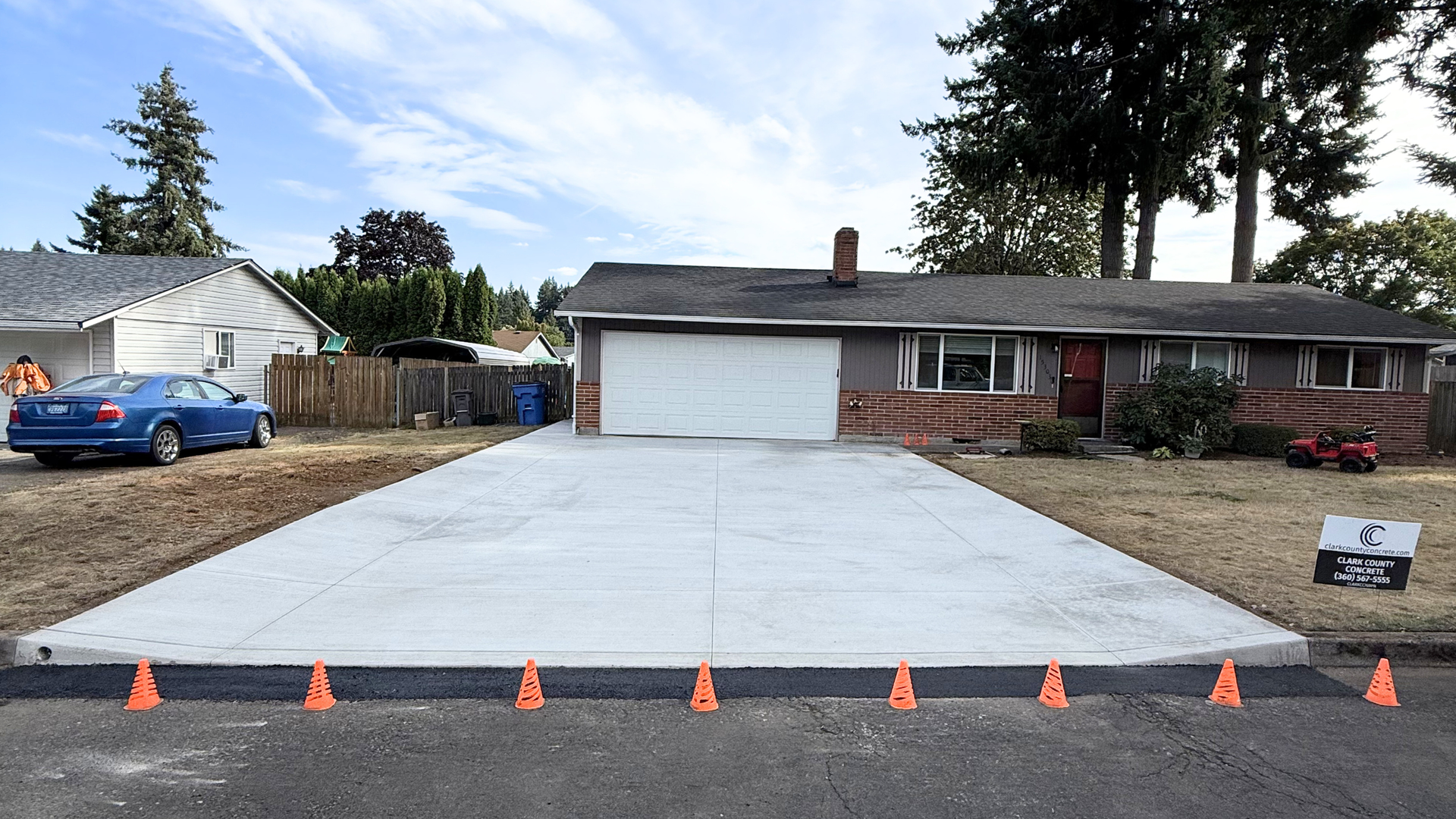 Freshly poured concrete driveway curing on a dry summer day in Clark County, Washington