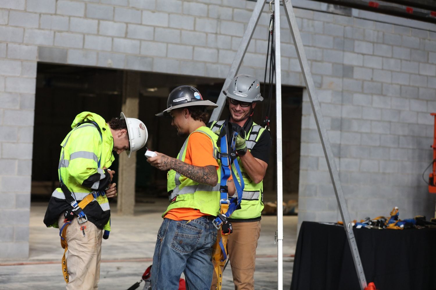 United Front Safety Solutions safety professional reviewing job site conditions with a construction crew