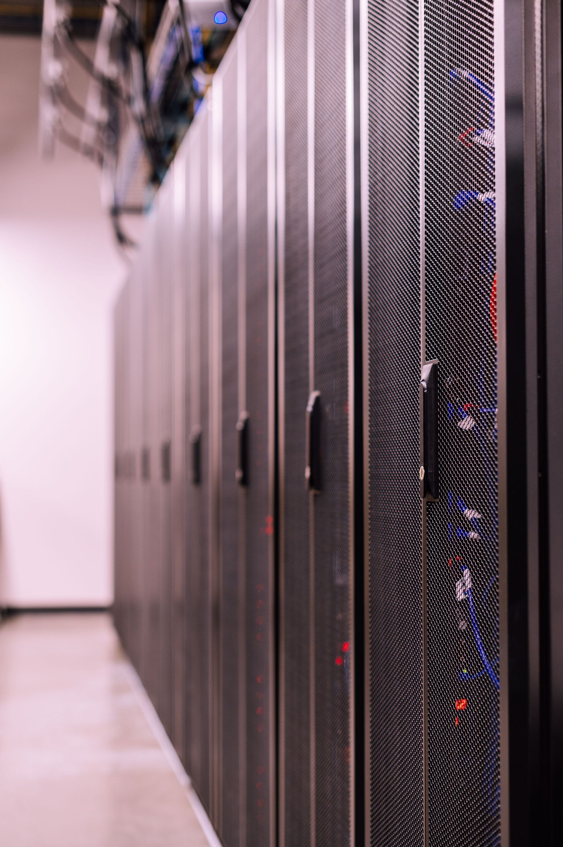 Rows of server cabinets inside a data center white space