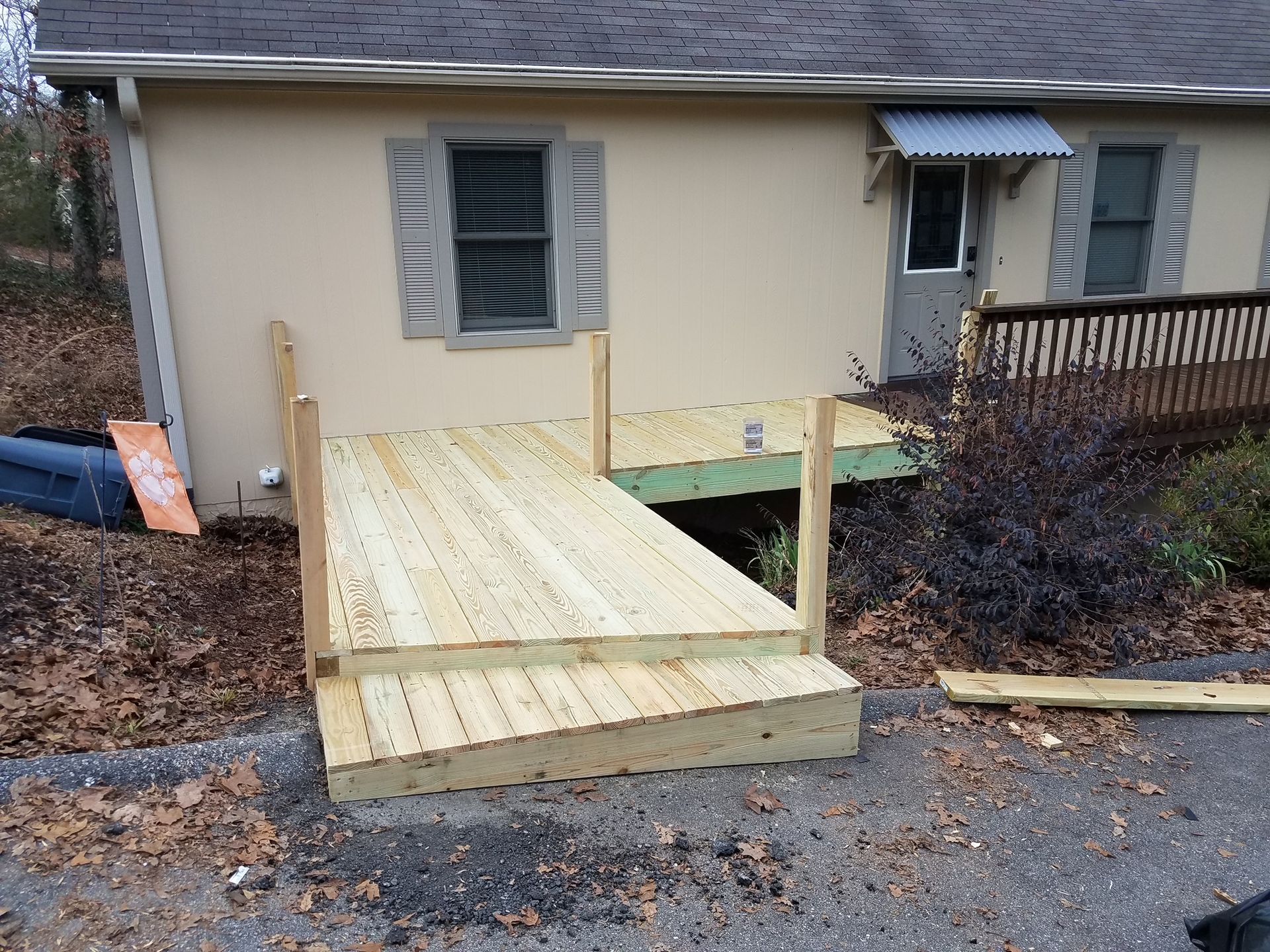 A house with a wooden deck in front of it