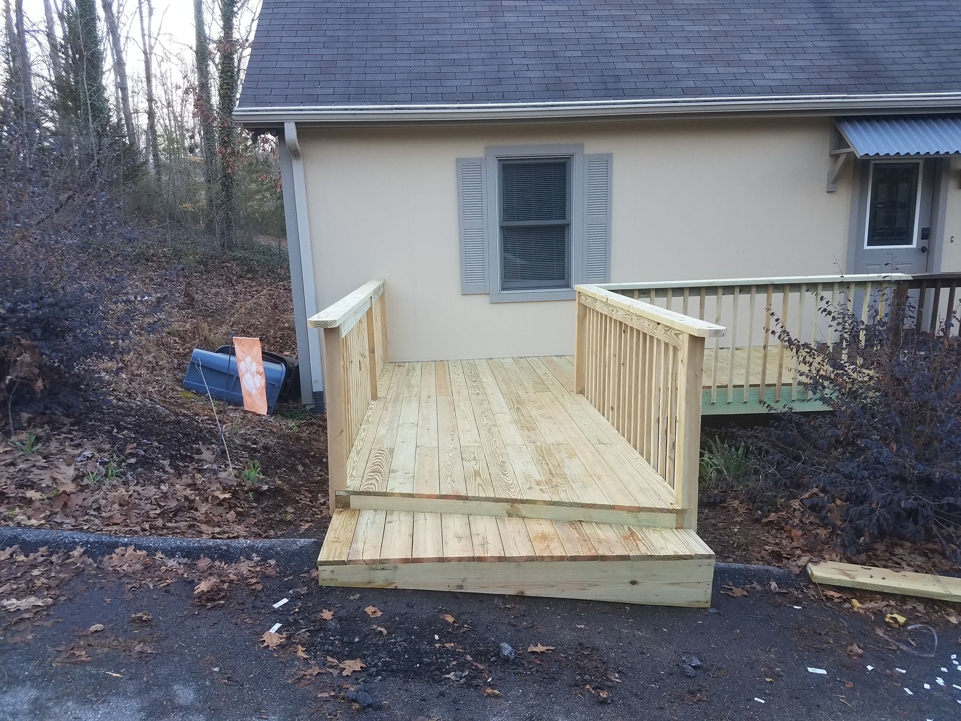 A small house with a wooden deck in front of it